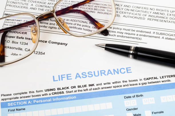 istock Life assurance application form with pen and glasses concept for life planning 1048345332