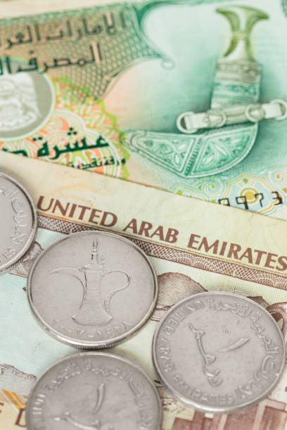 istock United Arub Emirates banknote and coins close-up 1048345610