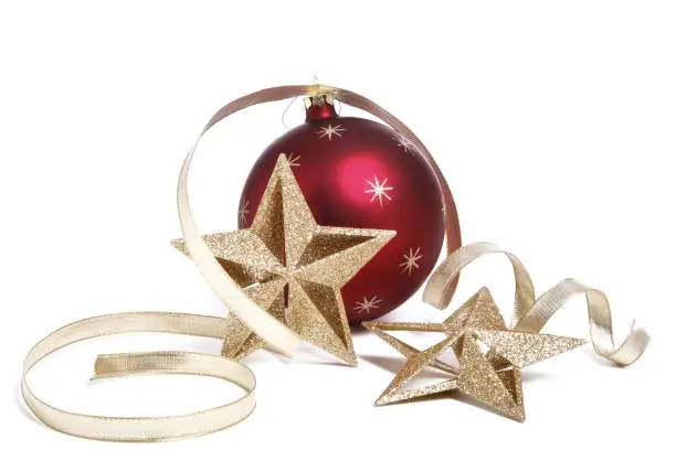 Photo of Christmas holiday red star bauble with gold stars and ribbon isolated
