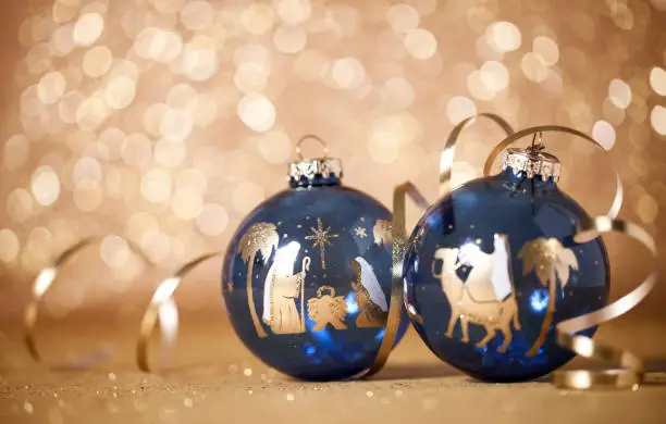 Christmas Nativity Scene and The Three Kings Baubles on a Gold Defocused Lights Background