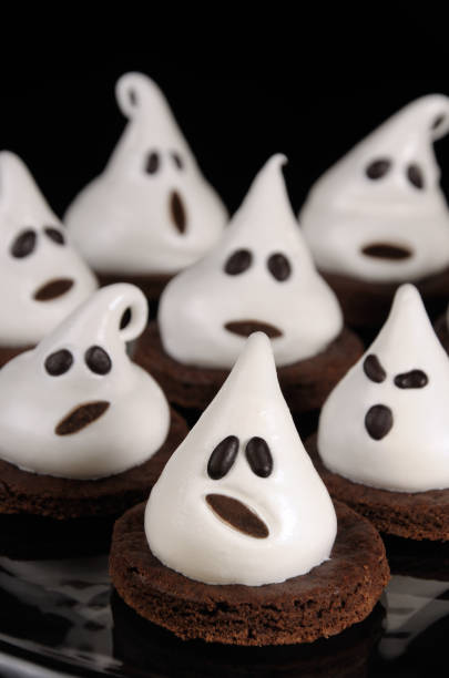 istock Chocolate biscuits decorated with meringue as a ghost for Halloween 1048349886