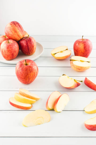 istock Whole and Cut Apples on White Wood 1048355804