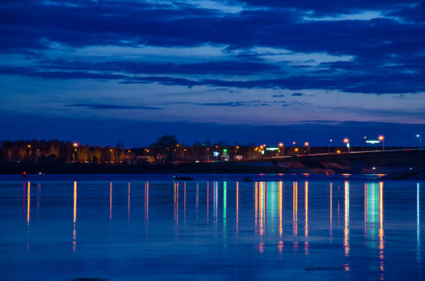 istock Blurred city lights with bokeh effect reflected on water 1048359184