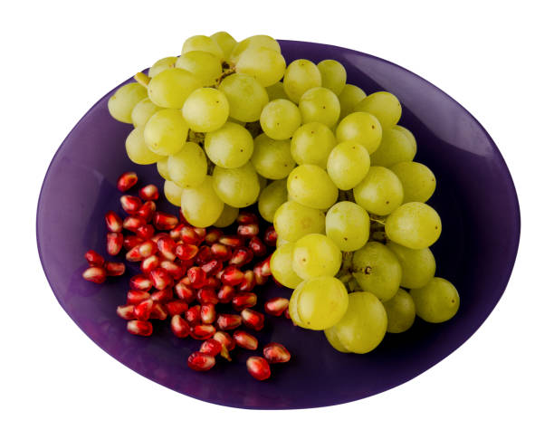 istock grapes and pomegranate isolated on white background. grapes and pomegranate on a plate . 1048359644