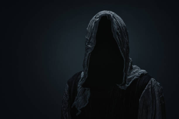 Silhouette of a grim reaper Silhouette of a Grim Reaper over dark gray background with copy space demon stock pictures, royalty-free photos & images