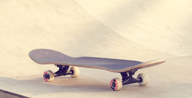 istock Skateboard standing on half pipe ramp at skate park. 1048376934