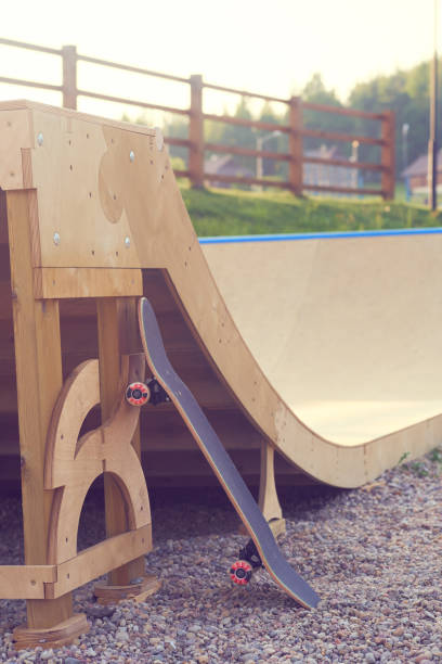 istock Skateboard standing on half pipe ramp at skate-park. 1048376942