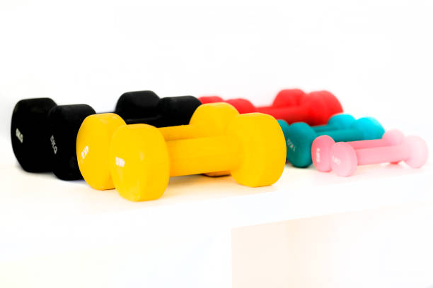 istock Colorful dumbbells against a white background 1048387308