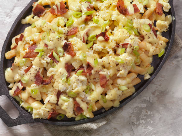 istock Breakfast Poutine with Hollandaise Sauce, Scrambled Eggs, Bacon and Cheese Curds 1048387392