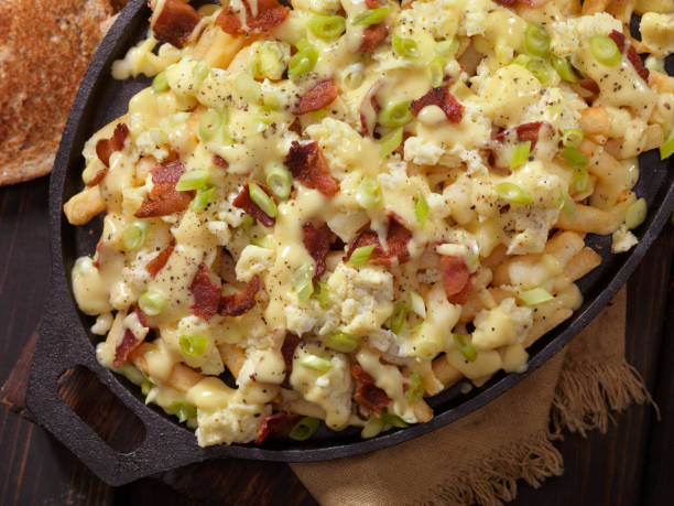istock Breakfast Poutine with Hollandaise Sauce, Scrambled Eggs, Bacon and Cheese Curds 1048387662