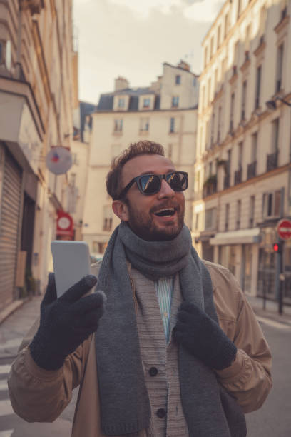 istock Attractive man using cellphone in the European city. 1048391062