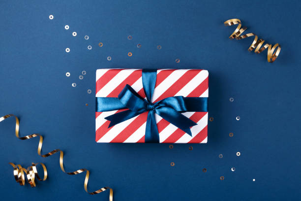 istock Gift box with blue ribbon decorated with sparkles. 1048394148