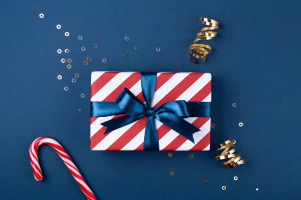 istock Gift box with blue ribbon decorated with sparkles. 1048394150