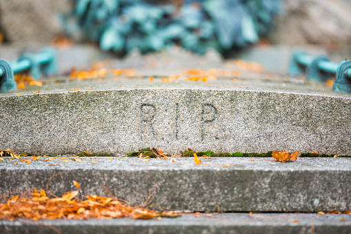 close up letters rip for rest in peace on old gravestone in the graveyard zentralfriedhof in vienna austria