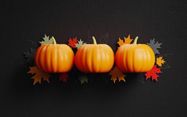 istock Pumpkins And Maple Leaves On Black Fabric Background 1048397990