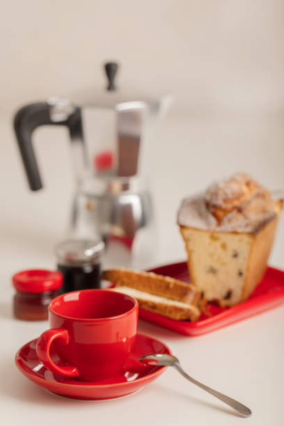 istock Breakfast - coffee and cupcake in a red bowl on a white background. 1048398068