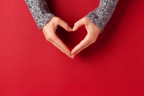 istock Female hands in shape of heart. 1048398136