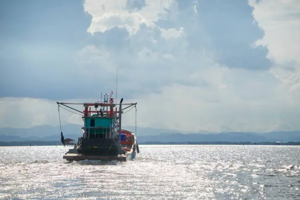 Photo of Fishing boat is out fishing. Fishermen is a career that has been popular in the seaside city of Thailand.