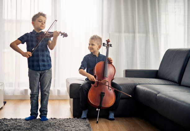 istock Two little boys practicing cello and violin together 1048401002