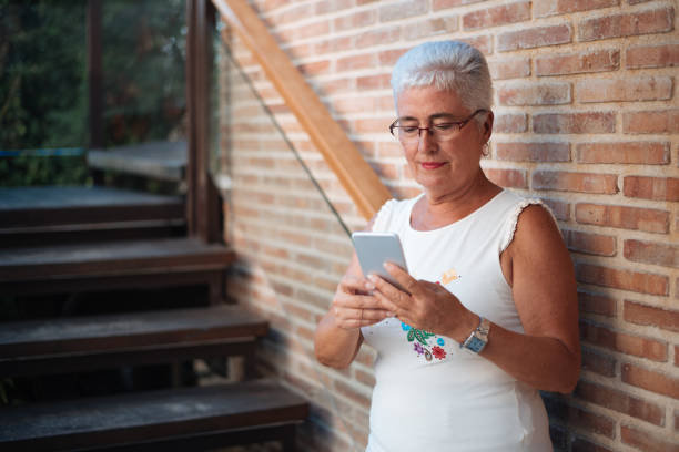 istock Happy elderly woman on the mobile phone 1048401778