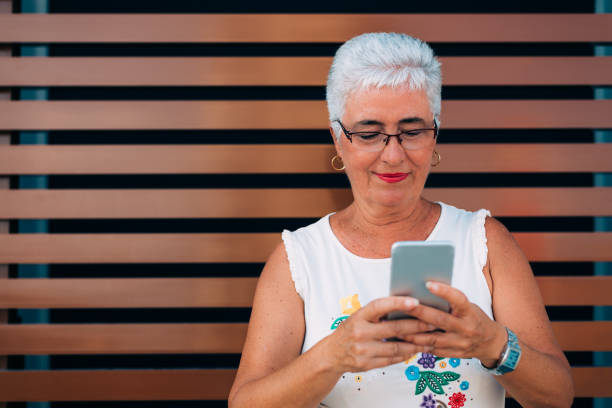 istock Happy elderly woman on the mobile phone 1048401798
