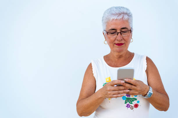 istock Happy elderly woman on the mobile phone 1048401830