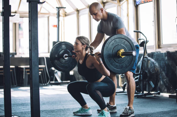 istock Fitness woman exercise with her personal trainer 1048402632