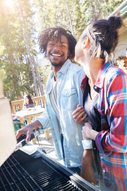istock Young couple grill together 1048402684