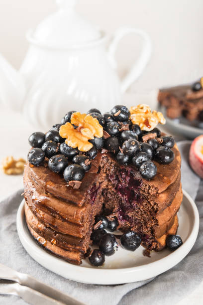 istock Stack of homemade chocolate pancakes with blueberries and chocol 1048405732