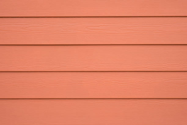 WOOD SUBSTITUTE WALL SIDING FOR BACKGROUND , ORANGE COLOR Orange Siding shunting yard stock pictures, royalty-free photos & images