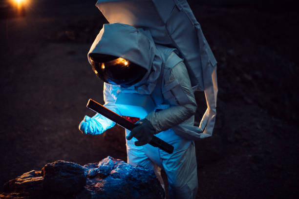 istock Astronaut collecting rock samples on Mars 1048408956