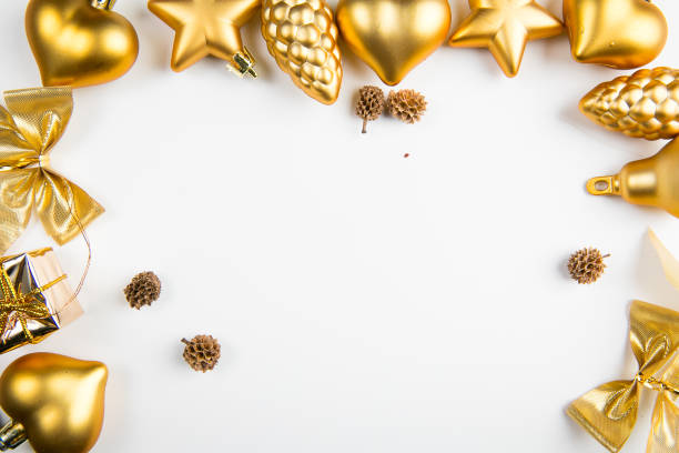 istock Golden color Christmas ornaments positioned as a frame on white background 1048409030