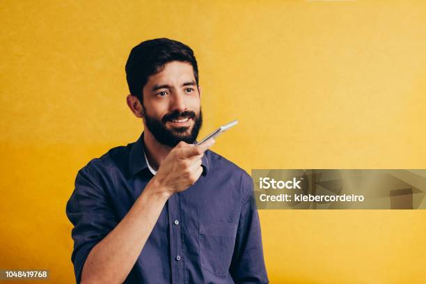 Leisure Technology Communication And People Concept Young Man Using Voice Command Recorder Or Calling On Smartphone Stock Photo - Download Image Now