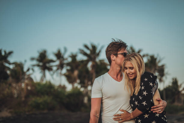 istock Beautiful couple walking on the beach 1048419938
