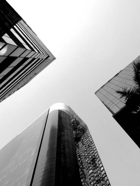 istock Black and white low angle view of three skyscrapers with reflective 1048420080