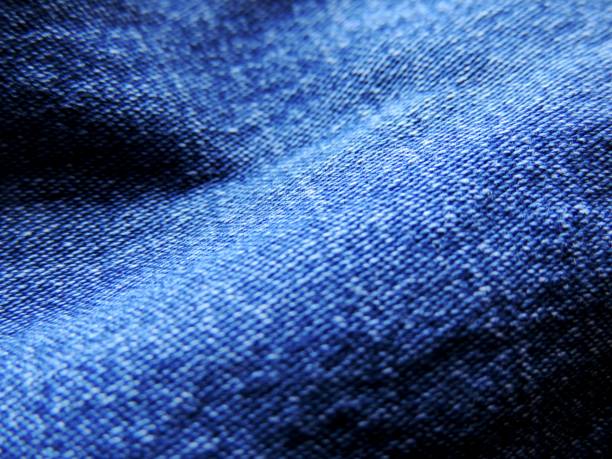 istock Close up image of blue natural looking textured denim jeans 1048422850