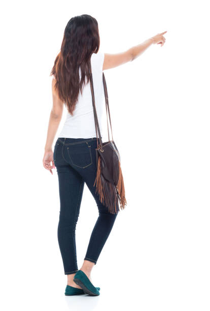 istock Cute latino female standing and pointing with her finger forward 1048426888