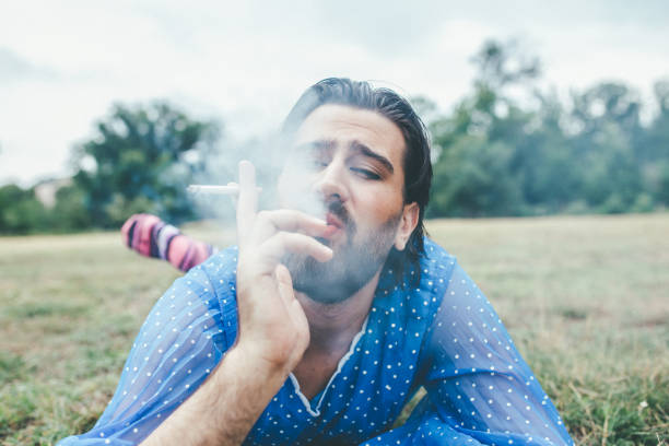 istock Transgender smoking cigarette in nature 1048427340
