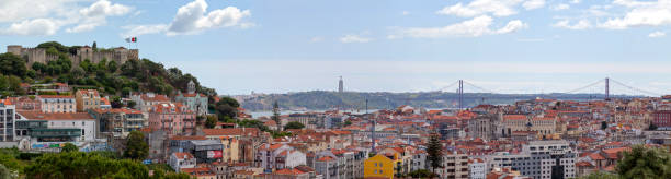 Panoramic view of Lisbon Lisbon, Portugal - June 01 2018: São Jorge Castle, the Santa Justa elevator, the ruins of the Carmo Convent, the 25th April bridge and the Sanctuary of Christ the King behind. santa justa lift portugal stock pictures, royalty-free photos & images