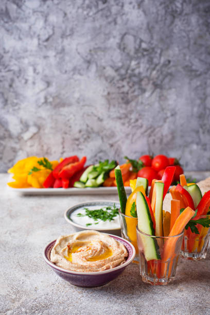 istock Snacks bar.  Vegetables sticks and hummus 1048432482