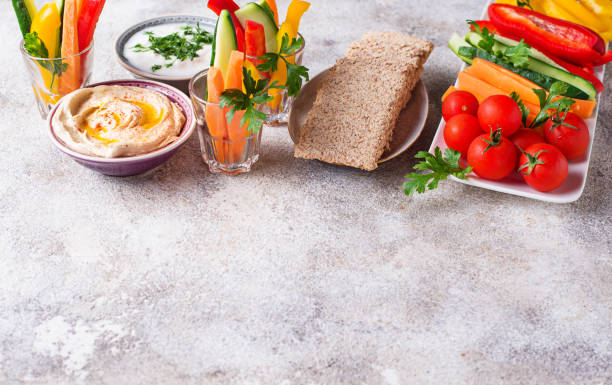 istock Snacks bar.  Vegetables sticks and hummus 1048432578