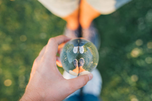 istock glass sphere and two feet 1048433040
