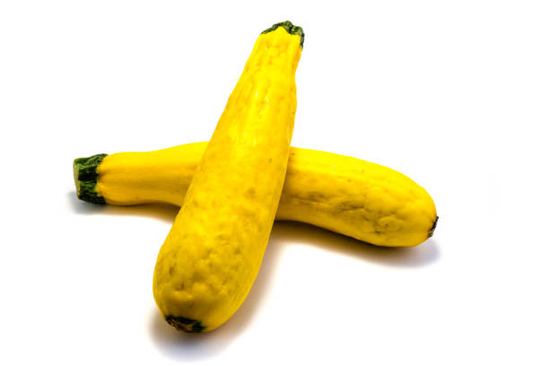 istock Two yellow zucchini isolated on white background 1048433080