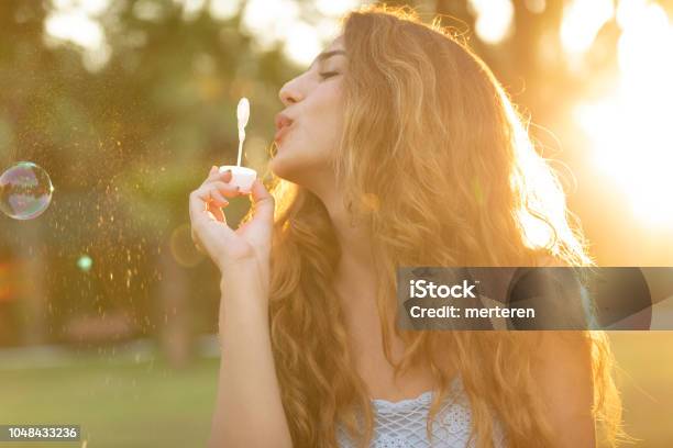 Girl Making Soap Bubbles Stock Photo - Download Image Now - Adult, Adults Only, Balloon