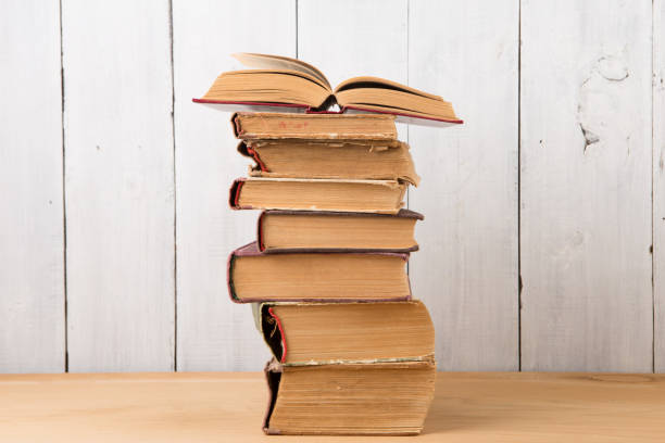 istock stack of books on the desk over wooden background 1048435920