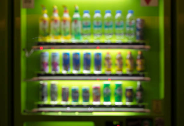 istock Blurred / Defocused abstract background of colorful soft drinks / juice bottles vending machines, taken in Thailand 1048436738