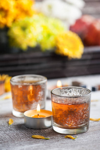 istock Glasses with lit candles and tea pot 1048437920