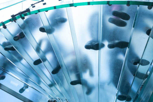 istock Feet On Glass Spiral Stairs 1048453786