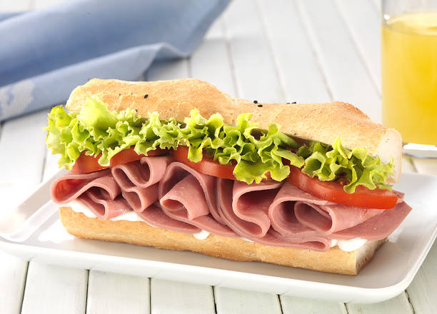 istock Sandwich with tomato, cheese,ham and fresh lemon juice 1048454152