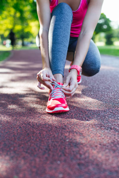 istock sportswoman tying shoelaces 1048454298